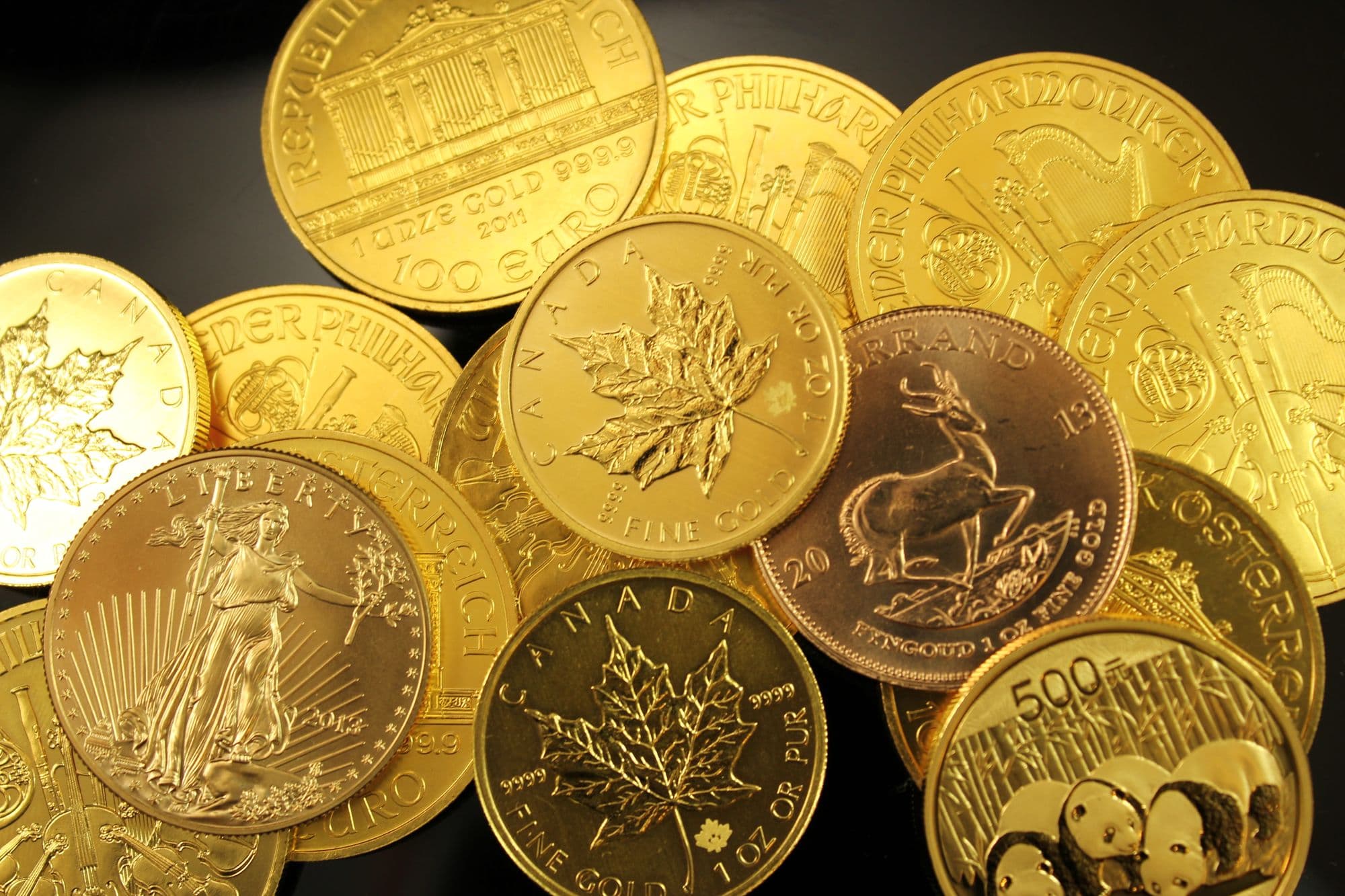Gold bullion coins from several countries in a pile
